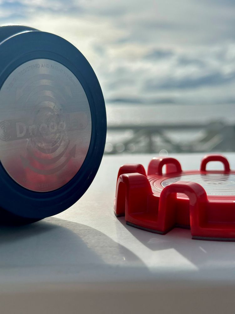 Close-up of the TwistLatch showing the red base on the right and the adapter plate on its side to the left.